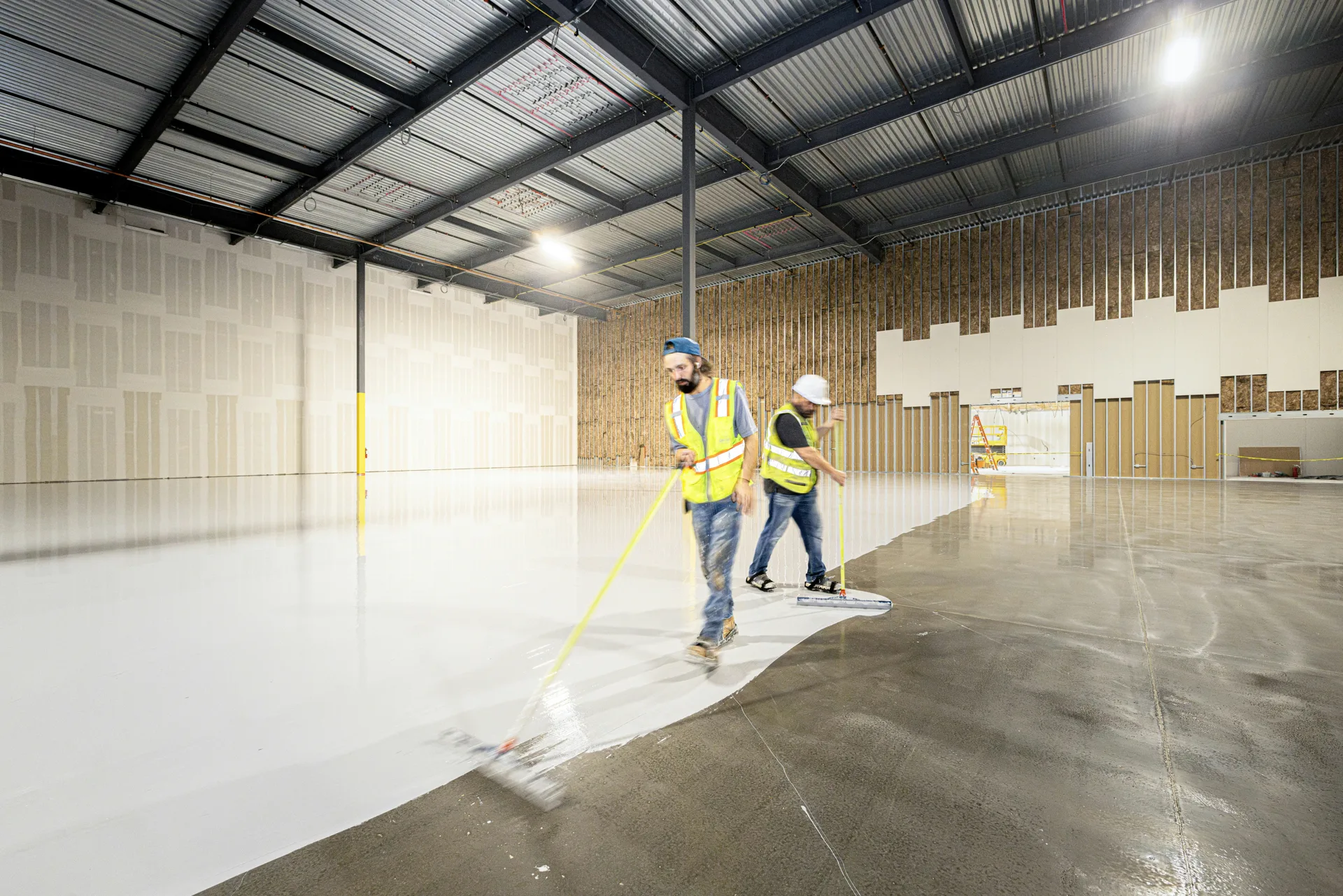 Rust-Oleum EpoxyShield being rolled onto a Portland concrete floor