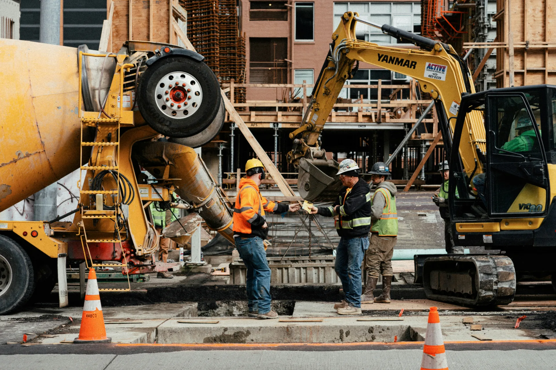 ready mix concrete pour on a Portland urban site with a mini excavator