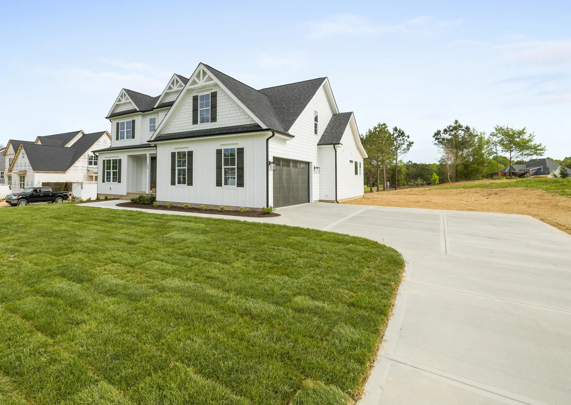 coloured concrete driveway curving up to a Portland farmhouse