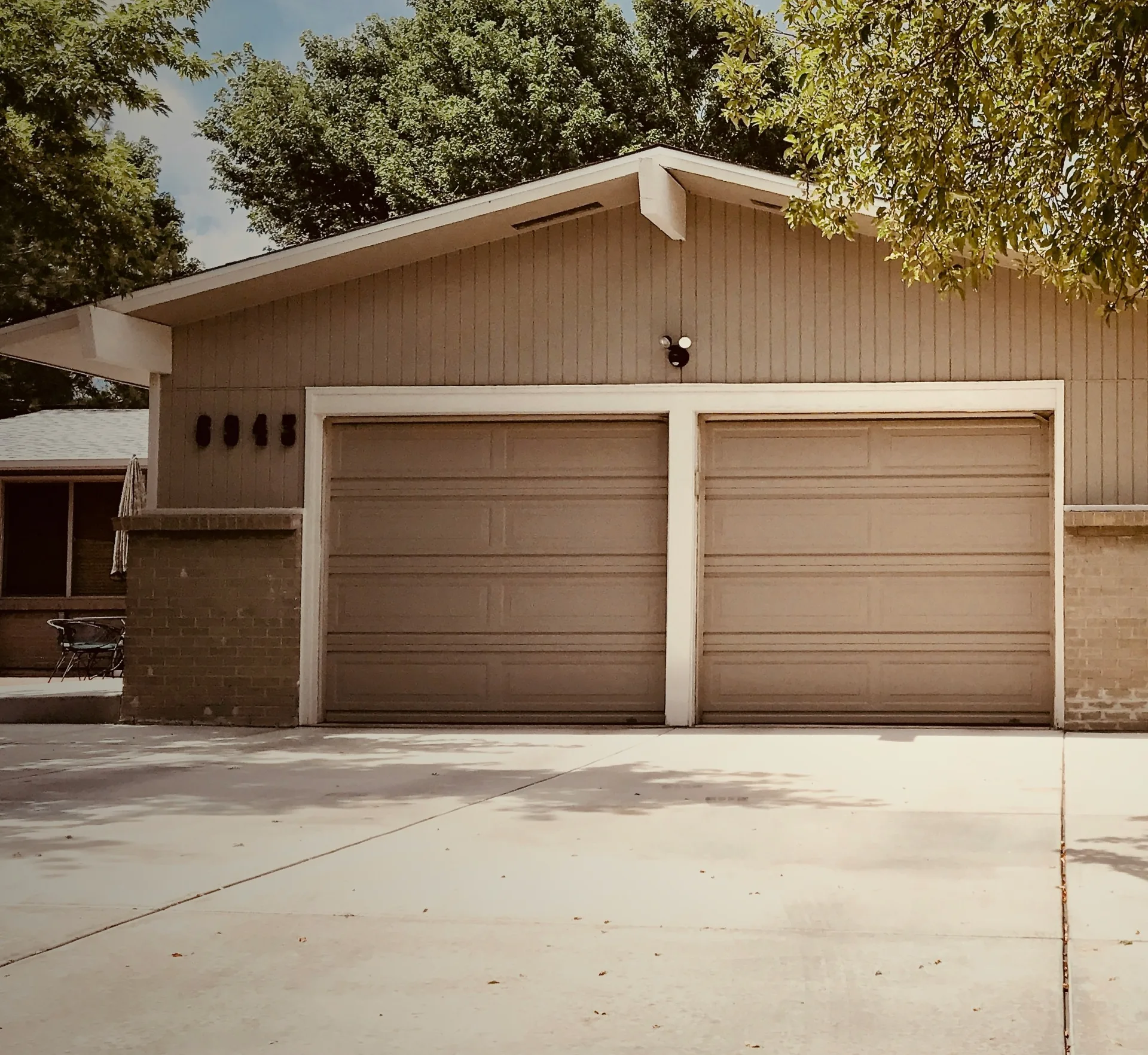 concrete driveway at a ranch home with a double garage in Portland