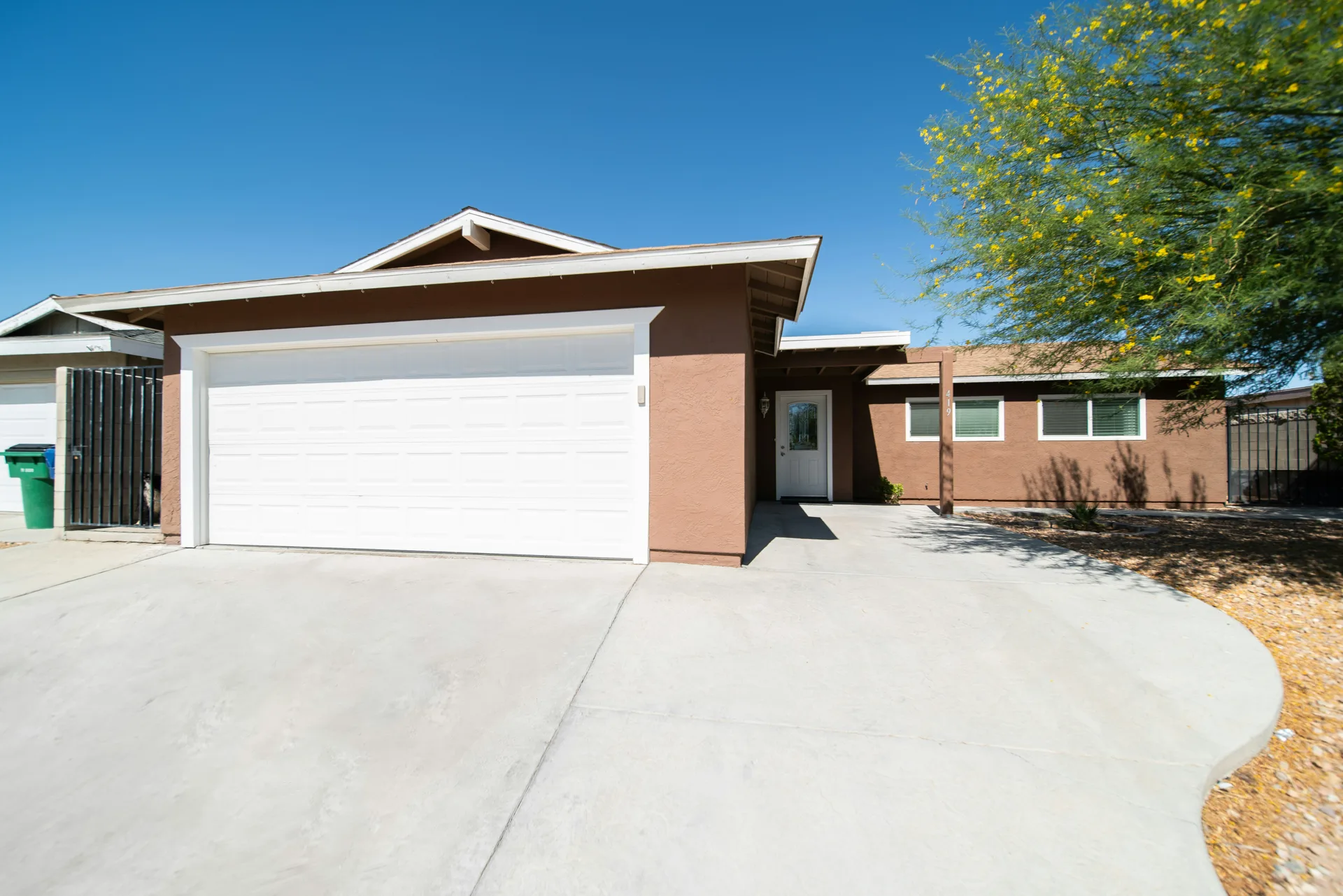 sealed concrete driveway at a Portland stucco home
