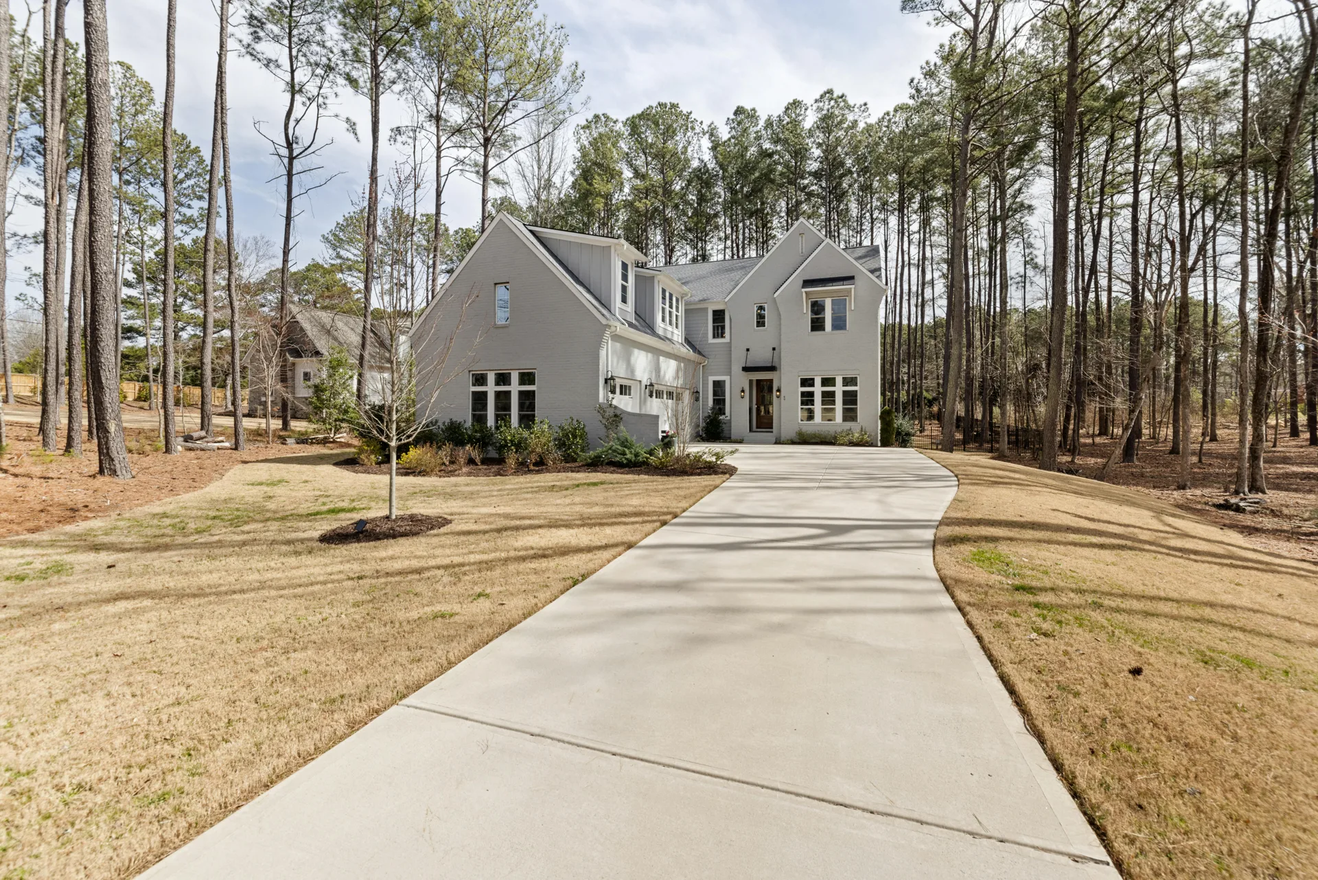 long curving concrete driveway through pines near Beaverton